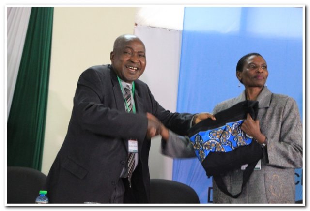 dvc are handing over a present to rep.cue during the launch